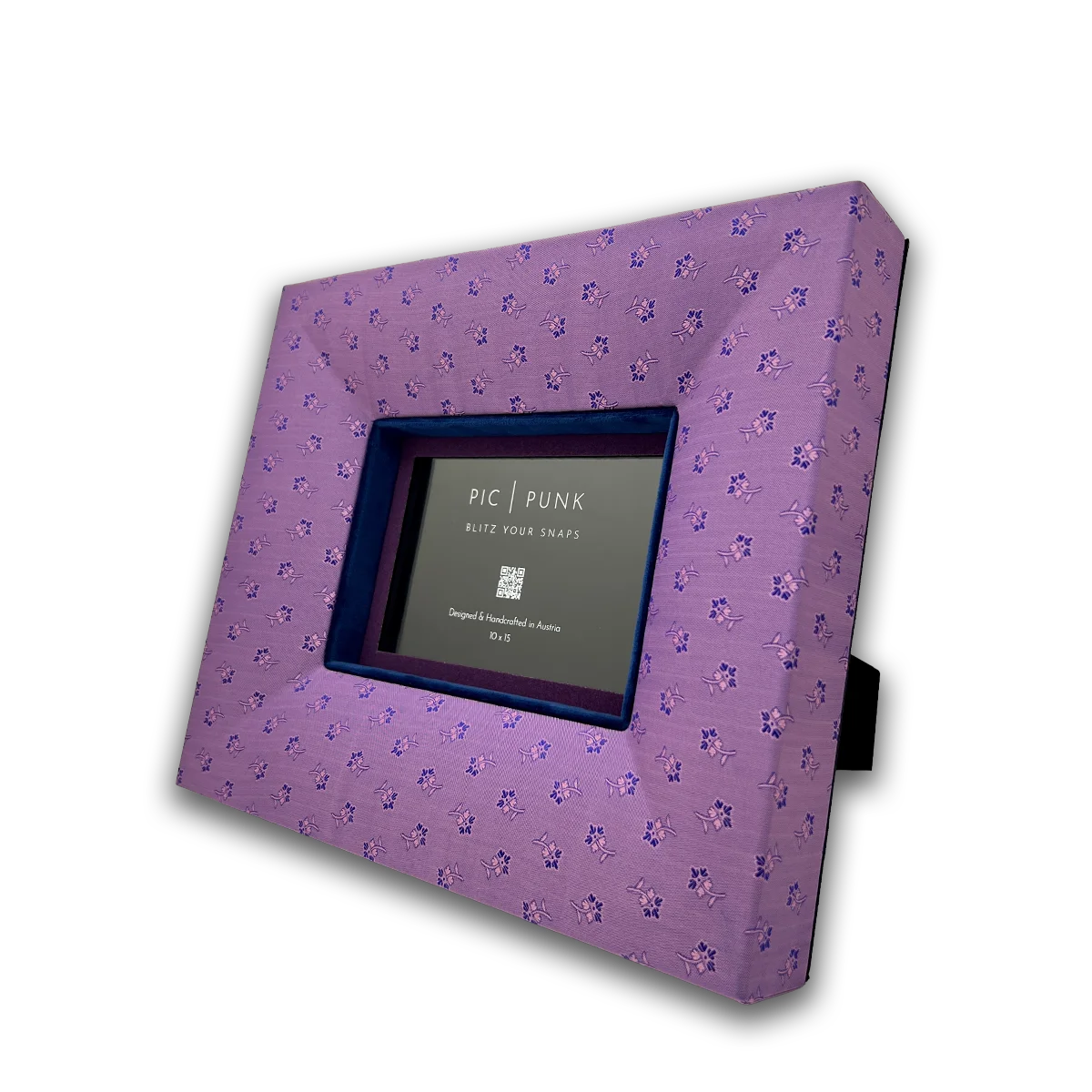 Handcrafted picture frame "Austrian Dirndl" covered in dusty pink dirndl-apron fabric with delicate floral pattern, dark blue velvet inlay and violet passepartout – handmade in Austria.